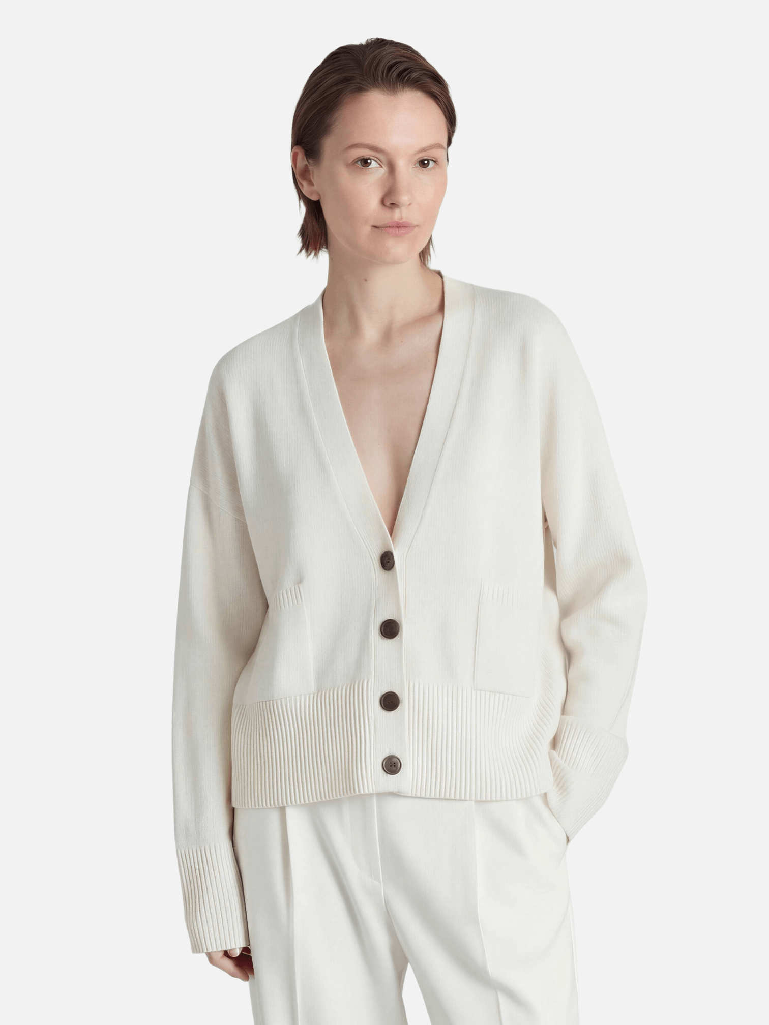 Woman wearing a white cardigan on a white background