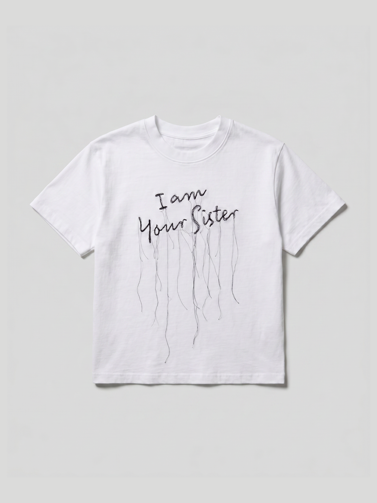 A white short-sleeve t-shirt with a black graphic embroidery that reads 'I am Your Sister' in a handwritten font, with several long dripping lines extending downward, shown against a light gray background.